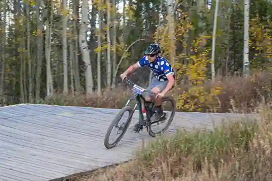 Longmont rider streaks passed fall colors on the bridges of the descent at Granby Ranch